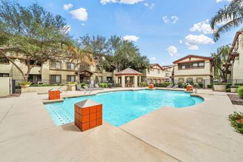 Resort style swimming pool with lounge seating and gazebo