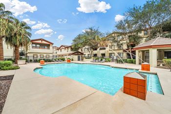 Swimming pool with orange brick columns and surrounding buildings