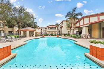 Community pool with cabana and lounge chairs