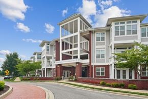 Waldorf apartment for rent - A modern apartment building with a red brick base and white upper floors.
