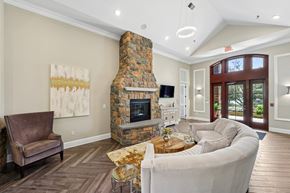 Frederick apartment for rent - Clubhouse with a stone fireplace and a brown leather chair.