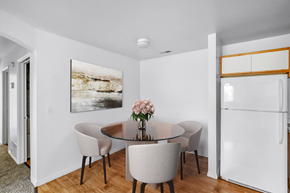 Lehi apartment for rent - Cozy dining nook with glass table and refrigerator at Mayflower Harbor at Pilgrims Landing Apartments, Utah
