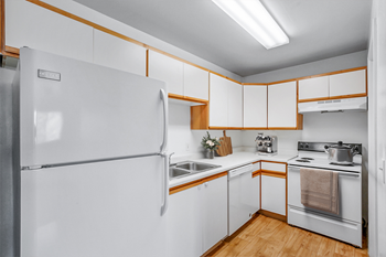 White kitchen with refrigerator and electric range