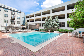 Denver apartment for rent - A pool surrounded by a brick patio and chairs.