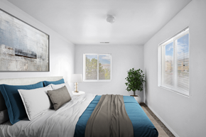 Lehi apartment for rent - Bedroom with blue bedding and two windows at Mayflower Harbor at Pilgrims Landing Apartments, Lehi, UT 84043