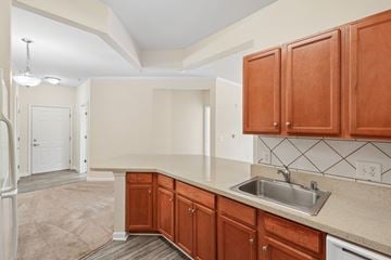 Waldorf apartment for rent - A kitchen with brown cabinets and a white sink.