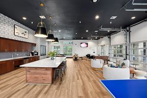 Austin apartment for rent - A modern kitchen with a long table and chairs.