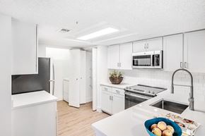 Boynton Beach apartment for rent - A kitchen with white appliances and cabinets.