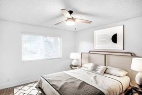Boynton Beach apartment for rent - A bedroom with a bed, a ceiling fan, and a painting on the wall.