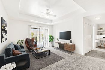 Contemporary living space with ceiling fan and patio access