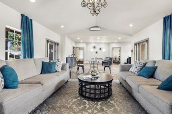 Clubhouse interior with modern seating and decorative chandelier