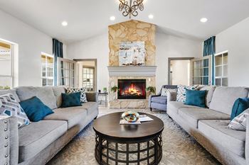 Elegant living area with stone fireplace and coordinated furnishings