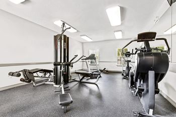 Well equipped fitness room with multiple exercise machines