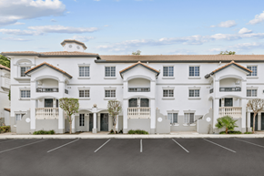 Fort Lauderdale apartment for rent - a large white building with balconies and a parking lot