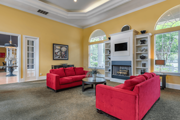 Sanford apartment for rent - A living room with red couches and a fireplace.