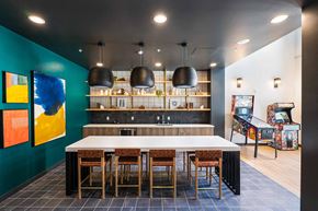 Oakland apartment for rent - A modern kitchen with a long table and chairs.
