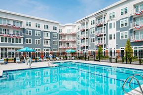 Bay Shore apartment for rent - a swimming pool with an apartment building in the background