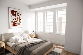 Bay Shore apartment for rent - A bedroom with a bed, a lamp, and a painting on the wall.