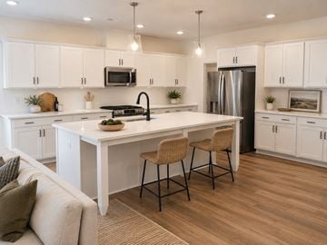 Wake Forest townhouse for rent - A modern kitchen with white cabinets and a large island.