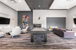 Pittsburgh apartment for rent - a games room with a ping pong table and a fireplace