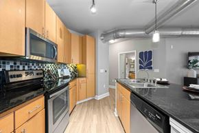 Charlotte apartment for rent - A Kitchen With Black Countertops at Mosaic South End Apartments, Charlotte, NC
