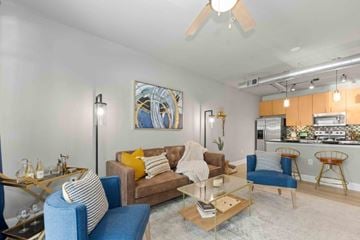 Charlotte apartment for rent - A living room with a blue couch and a painting on the wall.