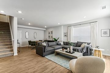 Flowery Branch townhouse for rent - A living room with a grey couch and a coffee table.