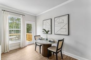Flowery Branch townhouse for rent - a dining room with a table and chairs and a window