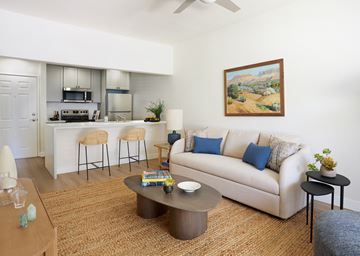 Newhall apartment for rent - A living room with a couch, a coffee table, and a painting on the wall.