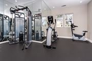 Cupertino apartment for rent - a gym with cardio equipment and weights on the floor