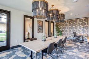 Santa Ana apartment for rent - a conference room with a long table and chairs and a large chandelier