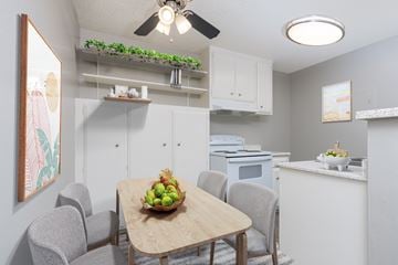 Anaheim apartment for rent - A kitchen with a table and chairs and a bowl of fruit on the table.