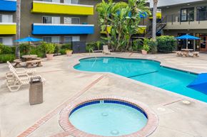 Anaheim apartment for rent - a large swimming pool with a building in the background