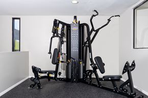 Anaheim apartment for rent - A black and grey gym machine sits in a white room.