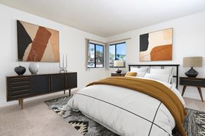 Azusa apartment for rent - A bedroom with a large bed and two abstract paintings on the wall.