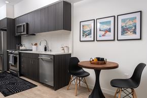 Bellevue apartment for rent - A kitchen with a table and chairs and three pictures on the wall.