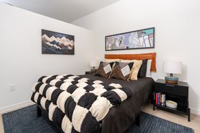 Bellevue apartment for rent - A bedroom with a large bed and two paintings on the wall.