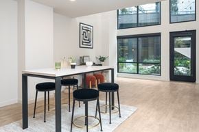 Redmond apartment for rent - A modern dining room with a white table and black stools.