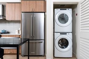Redmond apartment for rent - a washer and dryer in a kitchen next to a stainless steel refrigerator