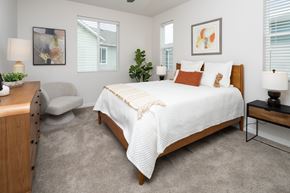 Erie townhouse for rent - A bedroom with a bed, nightstand, and chair.