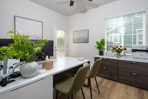 Erie townhouse for rent - A white kitchen with a table and chairs.