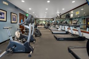 Erie townhouse for rent - A gym with a variety of exercise equipment including treadmills, stationary bikes, and elliptical machines.