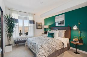 Redwood City apartment for rent - a bedroom with a bed and a green wall and a window