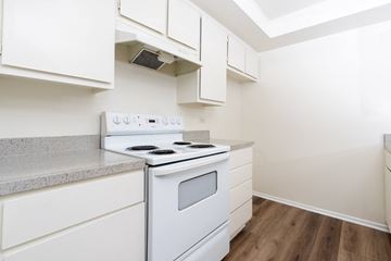 Los Angeles apartment for rent - A white stove and oven in a kitchen with white cabinets.