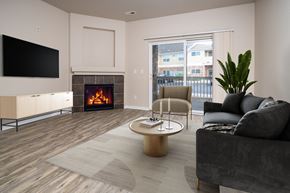 Arvada apartment for rent - A modern living room with a fireplace and a flat screen TV.