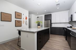 Aurora apartment for rent - A kitchen with a white counter top and black cabinets.