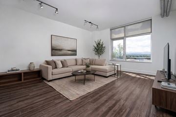 Denver apartment for rent - A living room with a couch, a coffee table, and a painting on the wall.