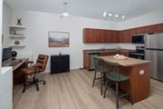 Rock Springs apartment for rent - A kitchen with a brown counter and a fridge.