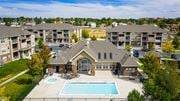 Rock Springs apartment for rent - A large house with a pool in front of apartment buildings.