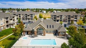 Rock Springs apartment for rent - A large house with a pool in front of apartment buildings.